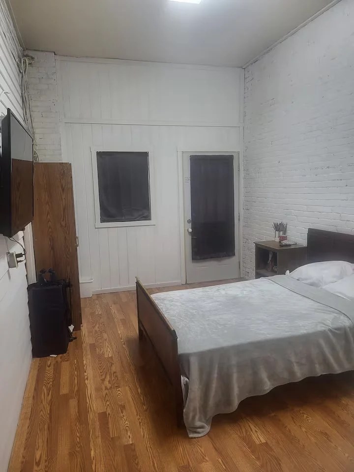 Bedroom with double bed and television