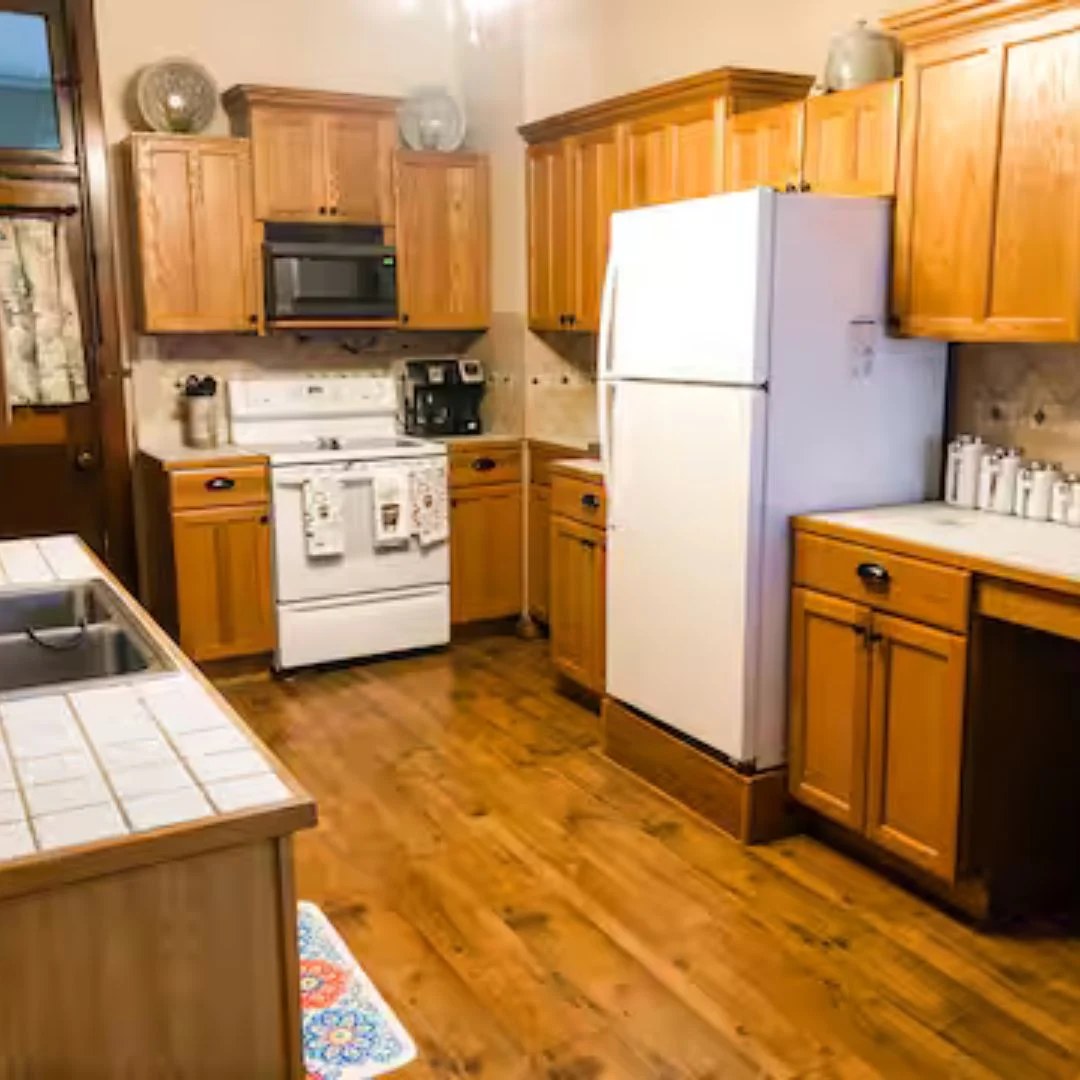 Warm, fully equipped kitchen with wood cabinetry